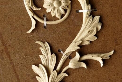 We attached this delicate appliqué woodcarving to a backerboard before shipping it.