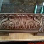 Art Nouveau cyma recta moulding, designed and hand-carved in walnut by Agrell Architectural Carving.