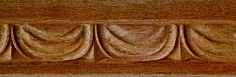 Wood-carved drapery moulding by Agrell Architectural Carving.